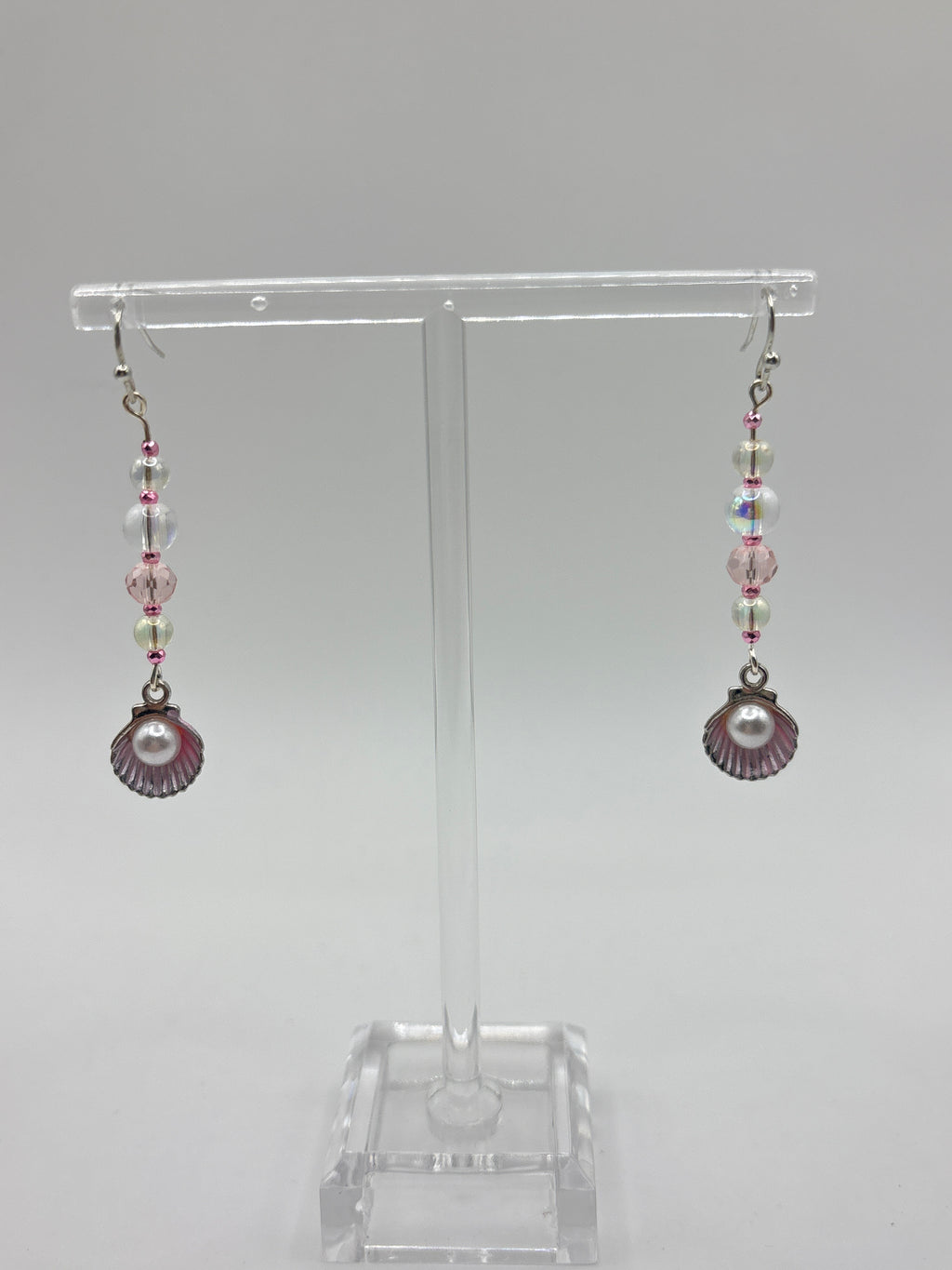 Pink shell with silver tone, pearl, bubbles and crystal.