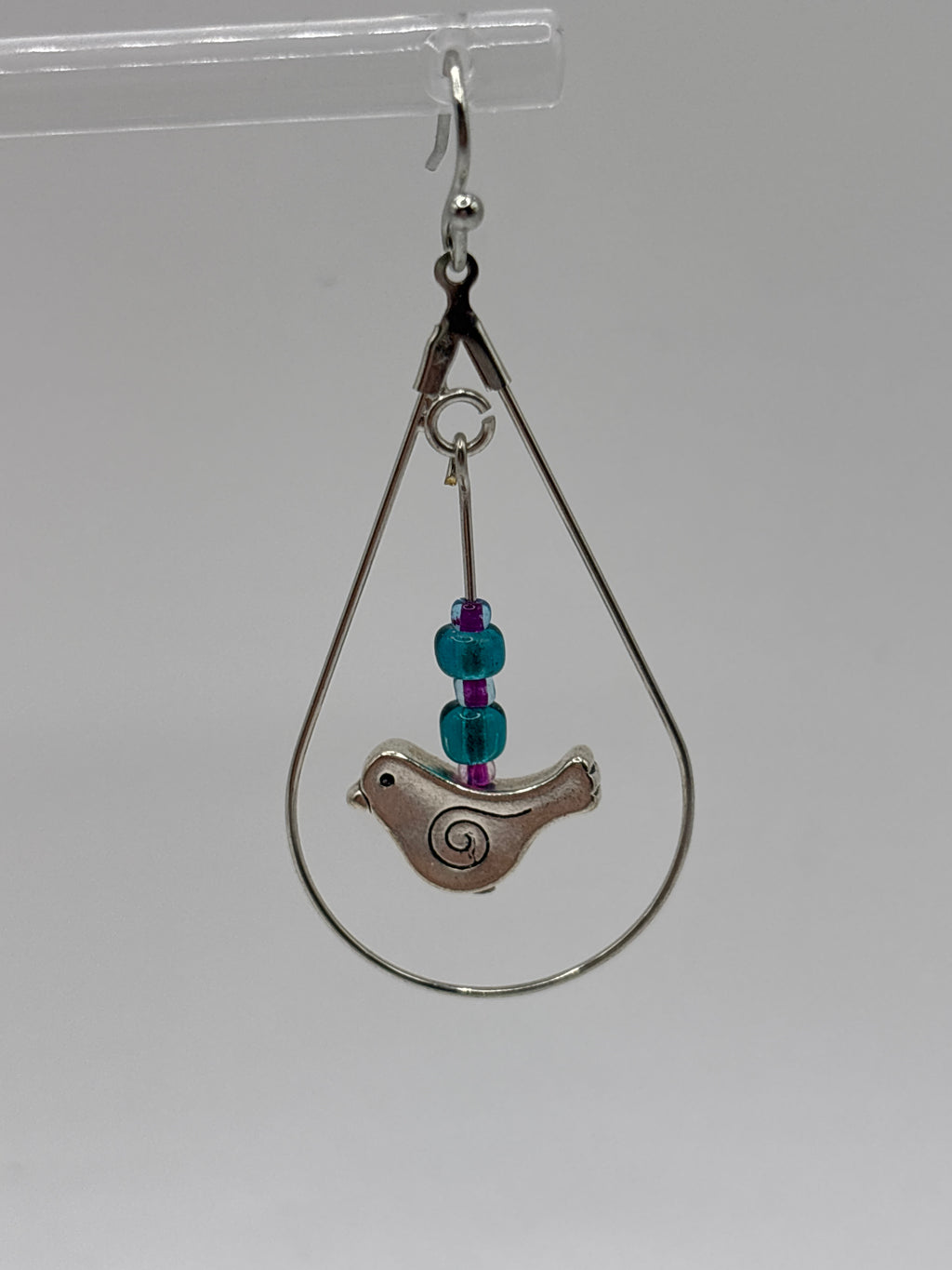 Bird in circle holding glass globe