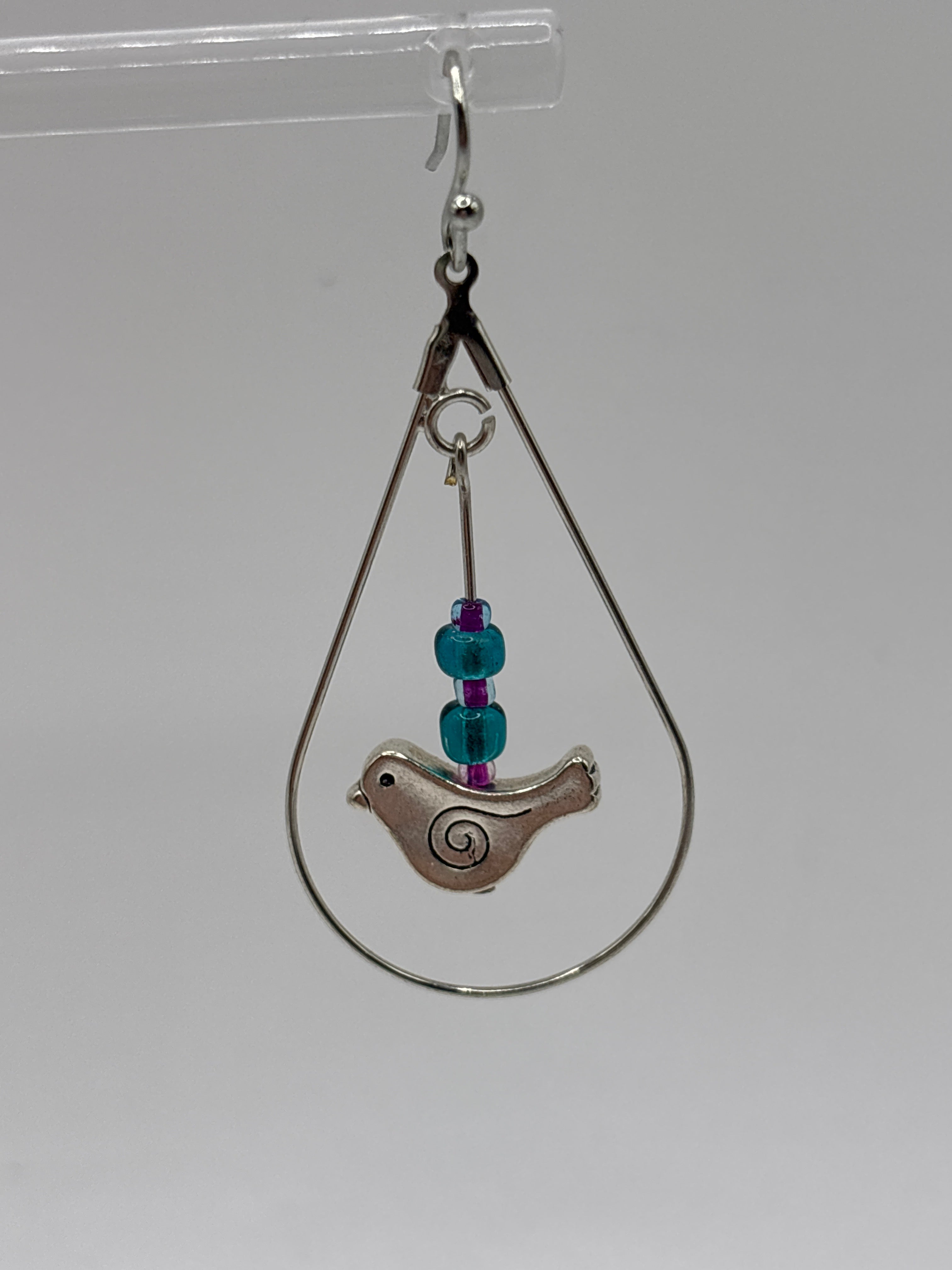 Bird in circle holding glass globe