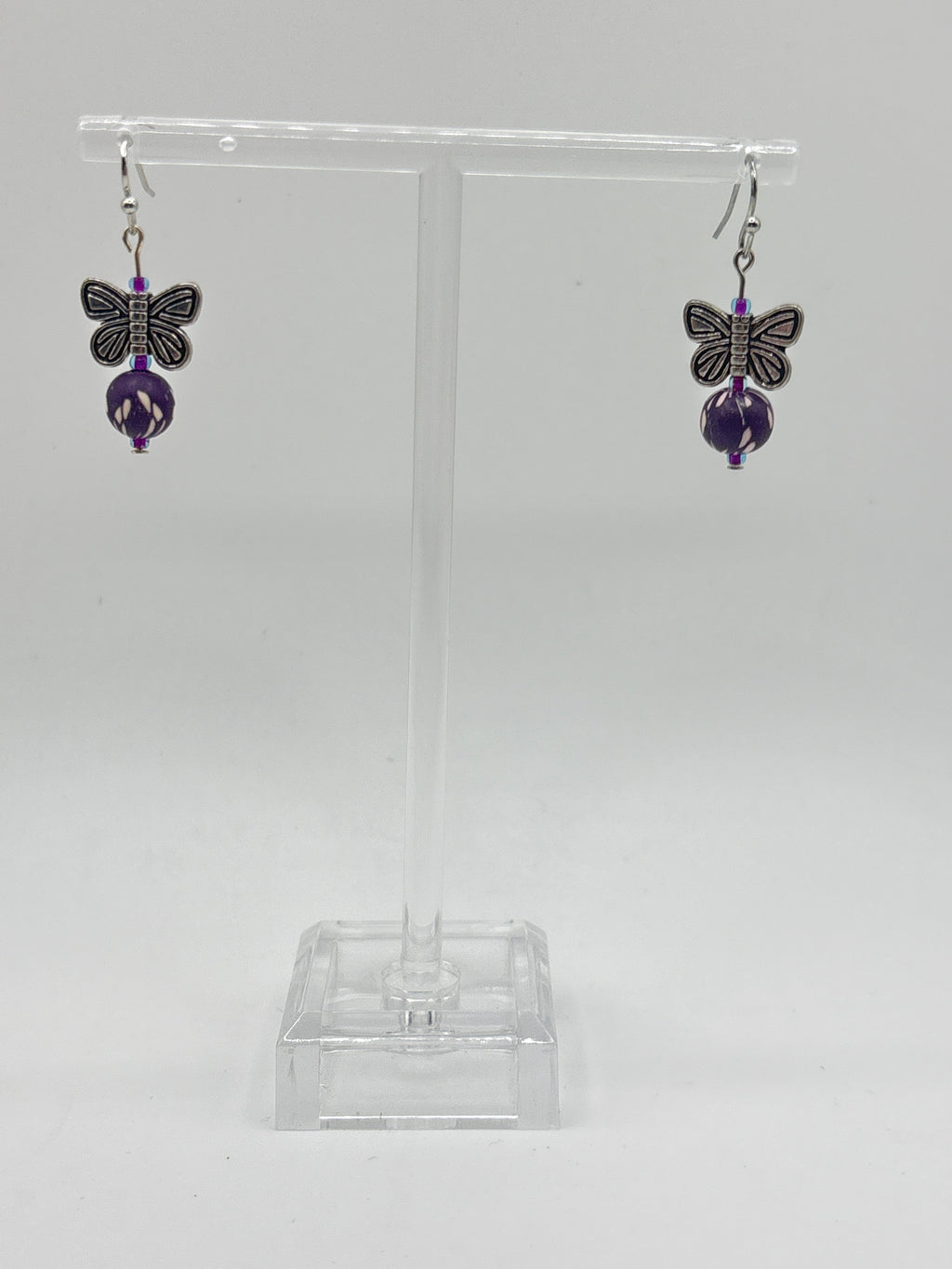Silver tone butterfly with dark purple bead
