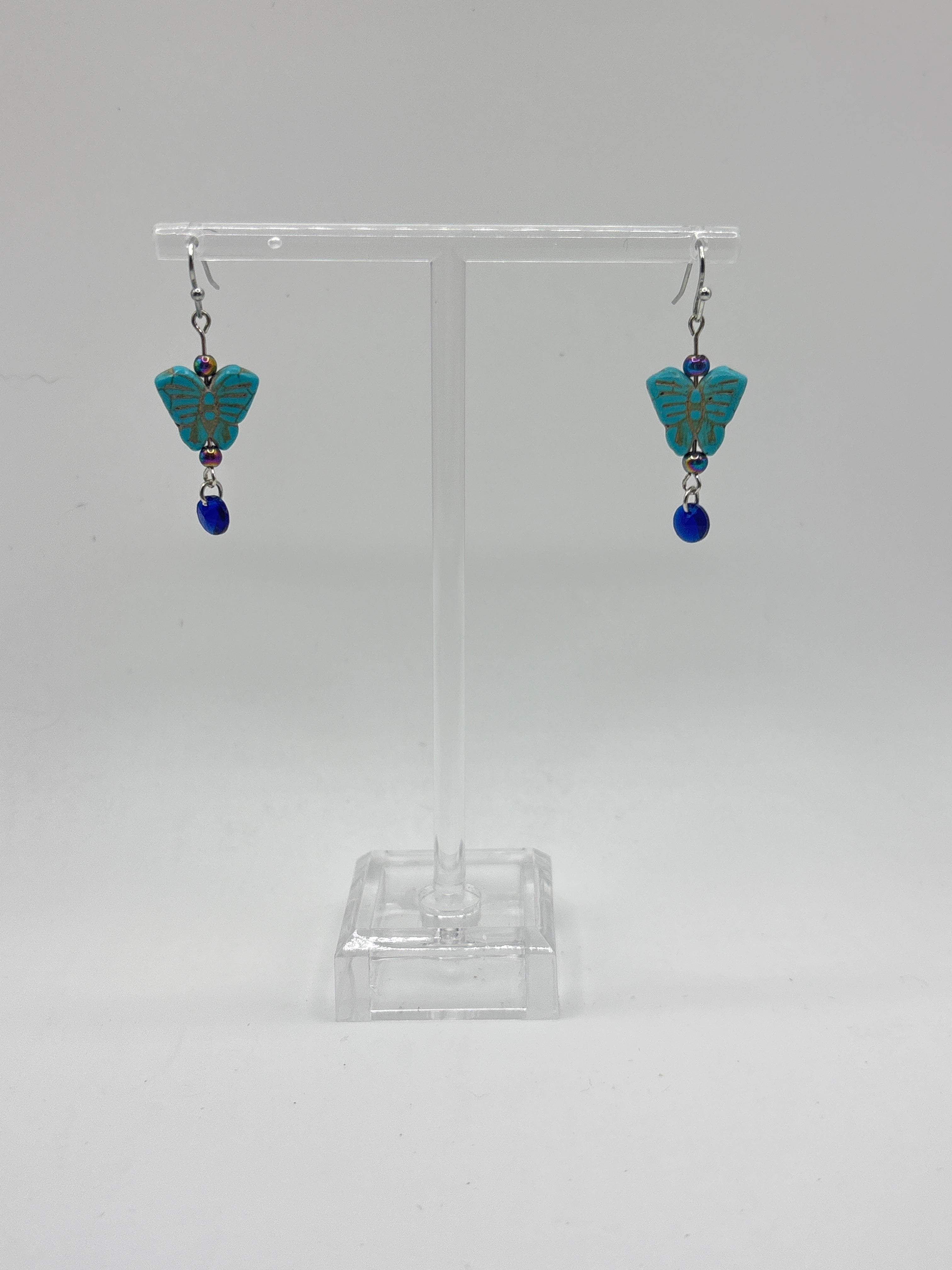 Turquoise small butterfly with iridescent bead