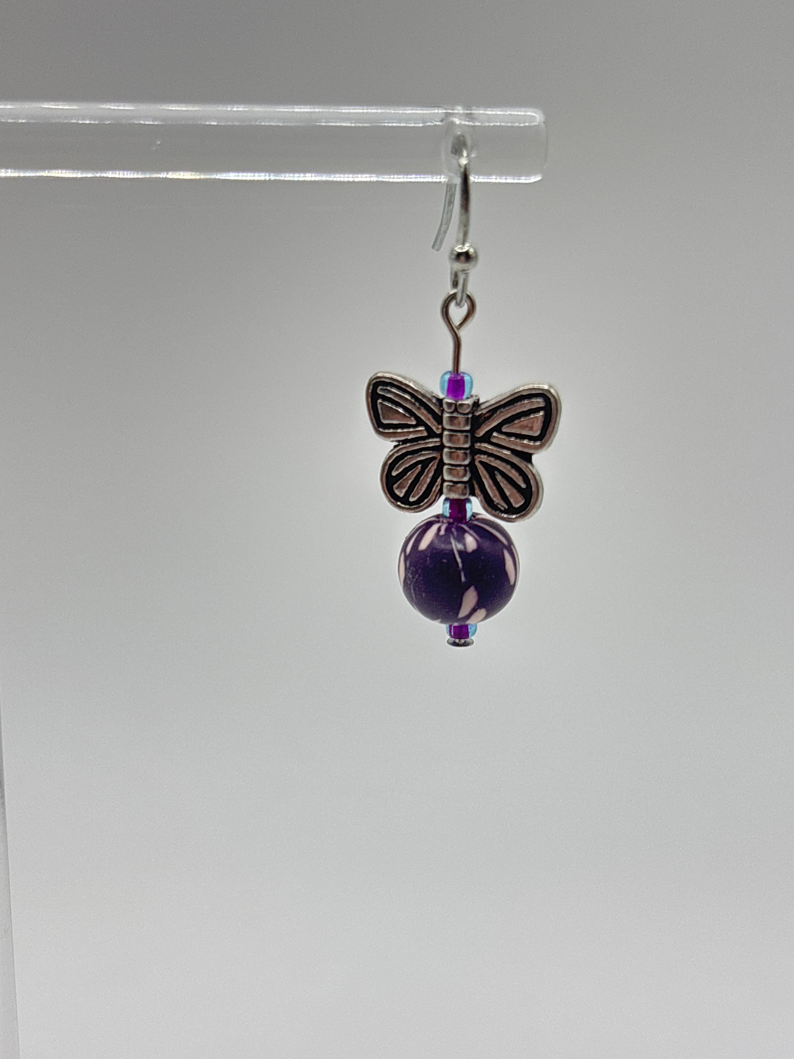 Silver tone butterfly with dark purple bead