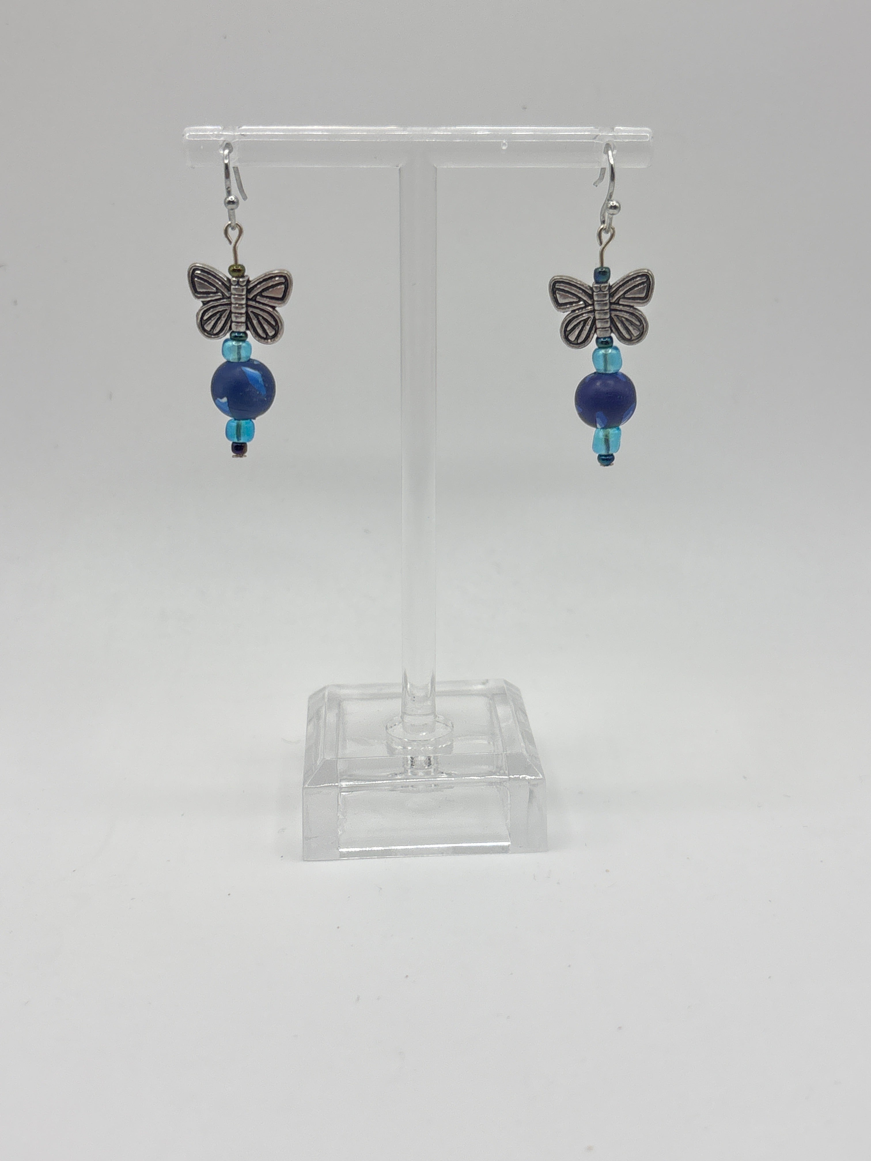 Silver tone butterfly on navy bead