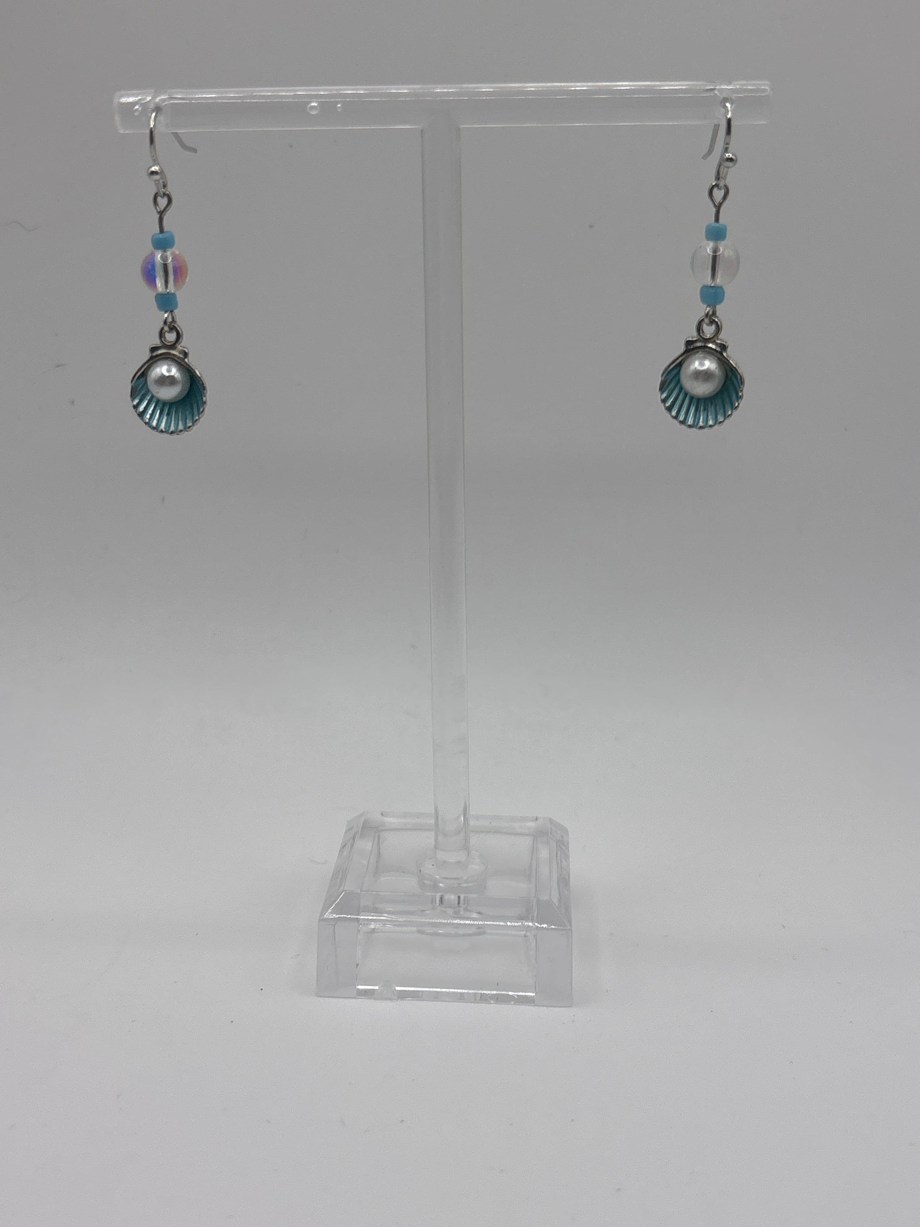 Silver tone shell with blue accents and pearl