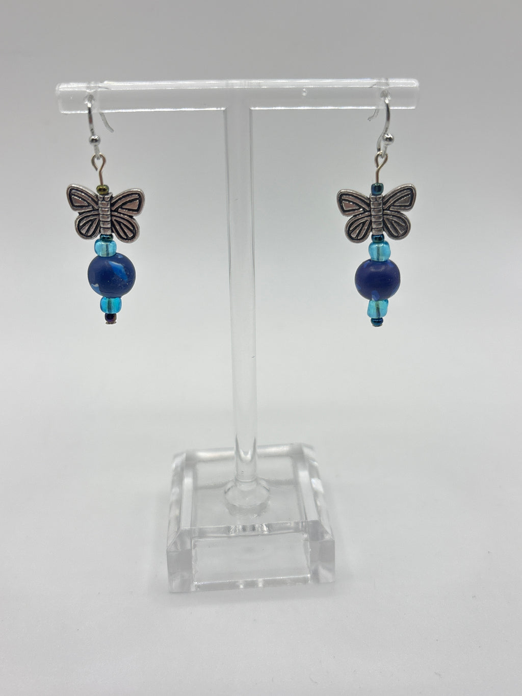 Silver tone butterfly on navy bead