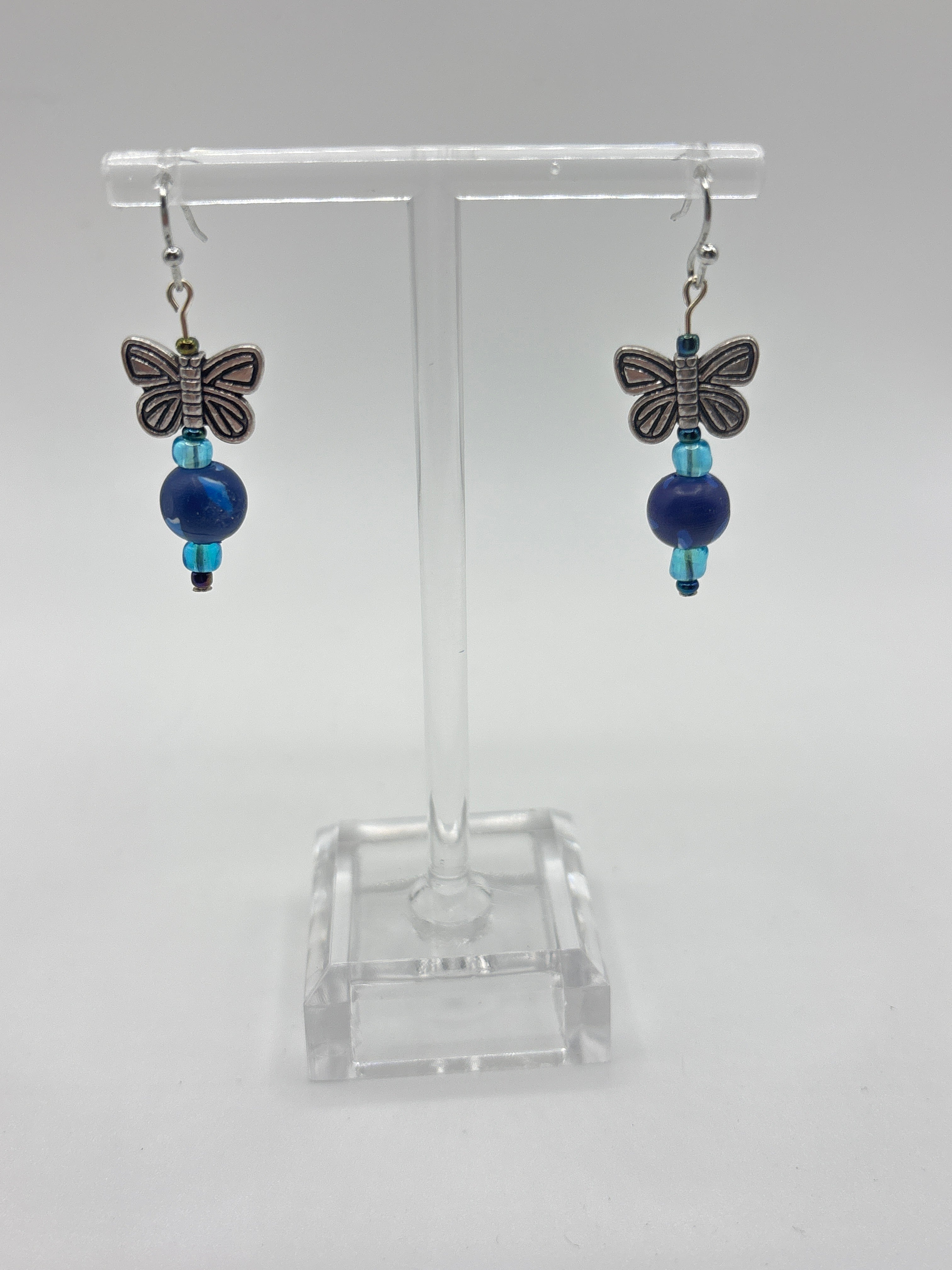 Silver tone butterfly on navy bead