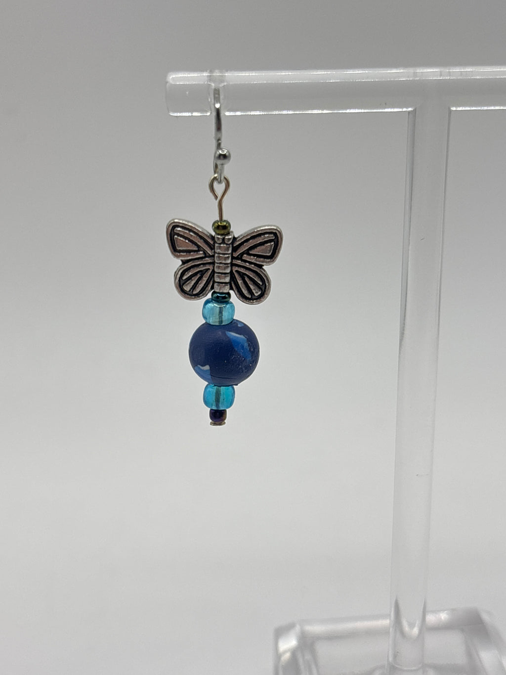 Silver tone butterfly on navy bead