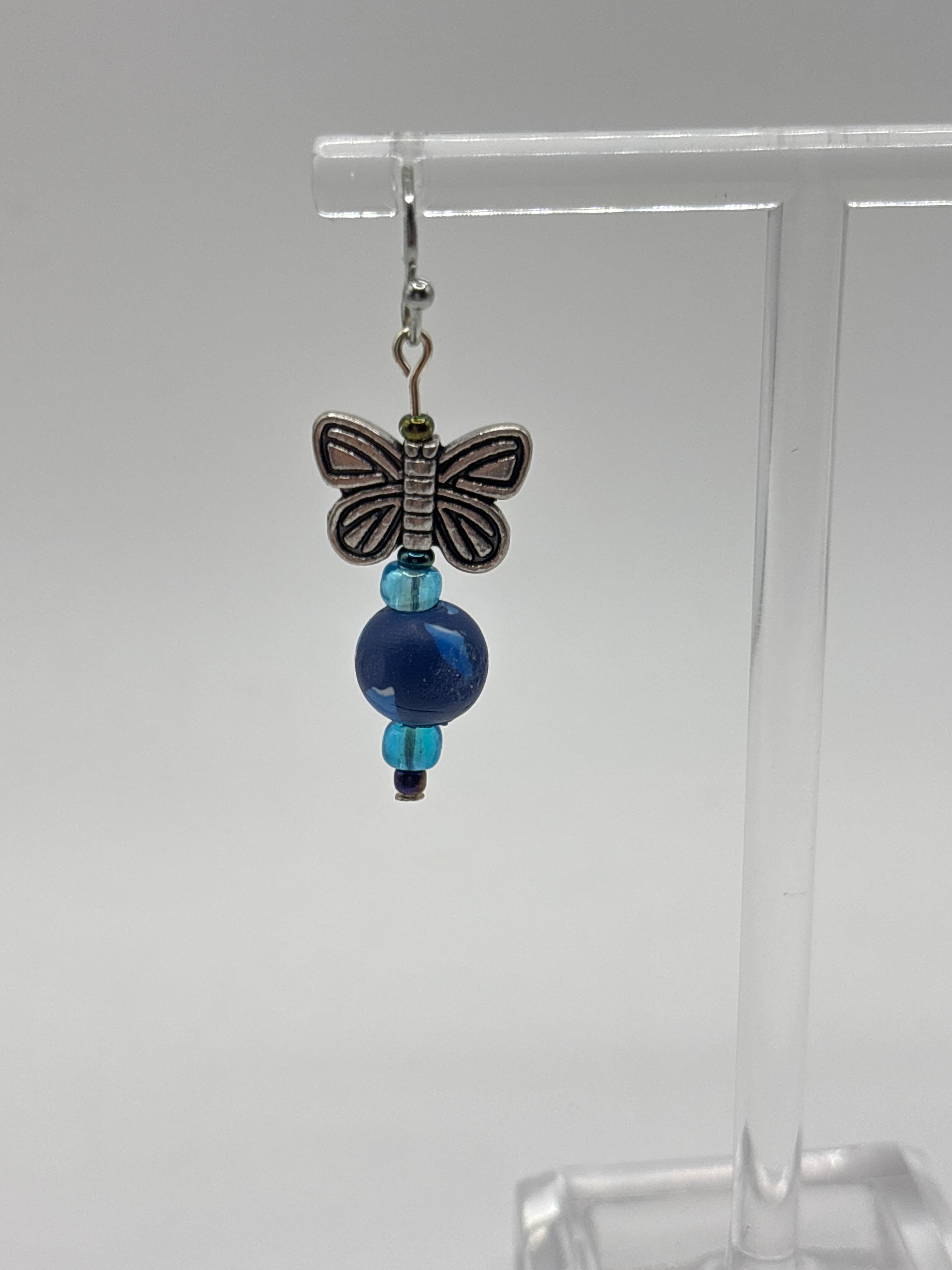 Silver tone butterfly on navy bead