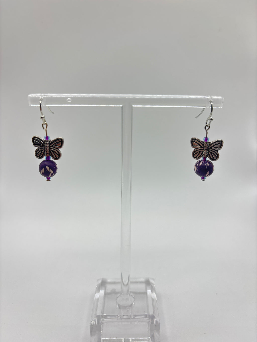 Silver tone butterfly with dark purple bead