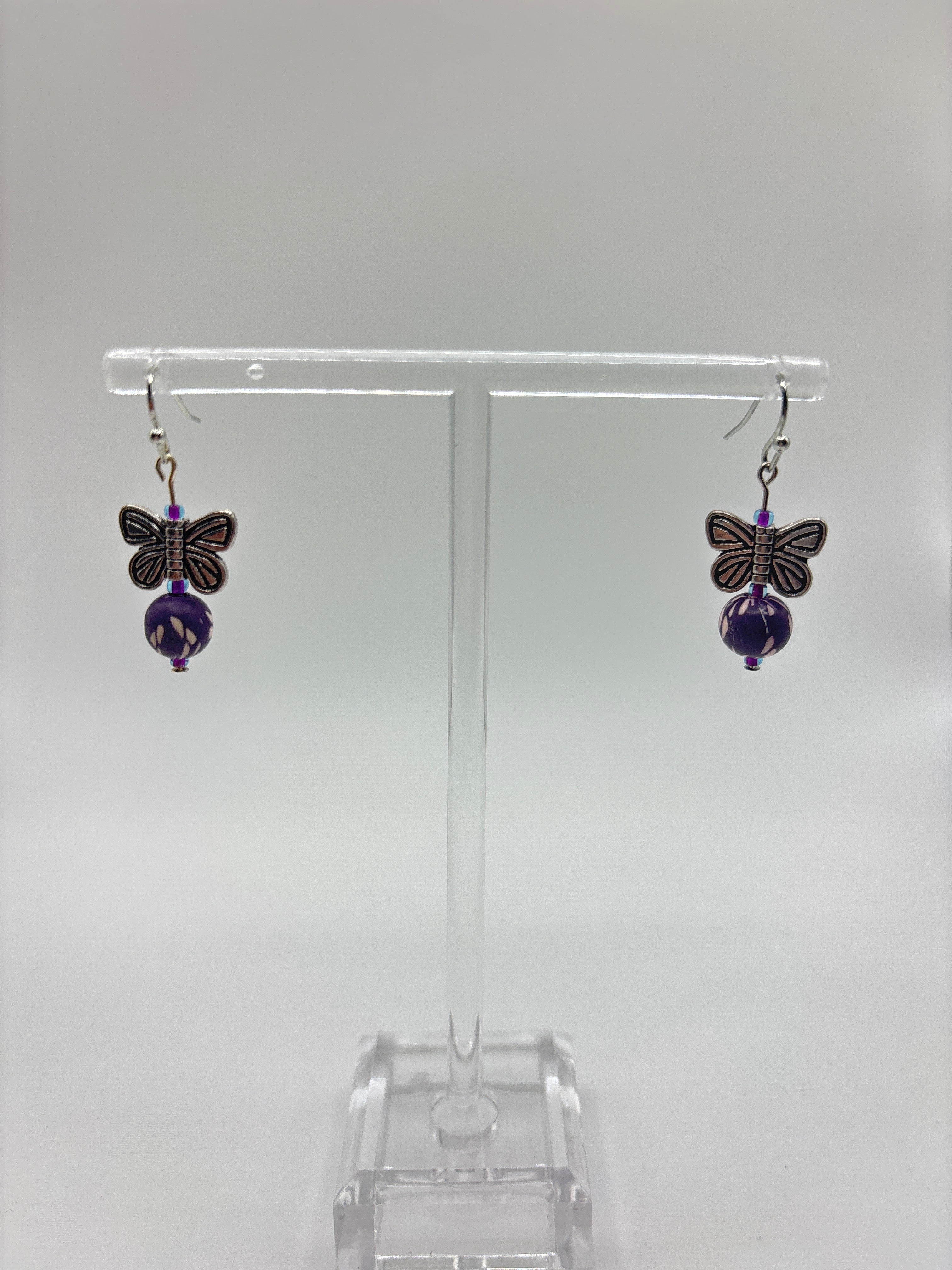 Silver tone butterfly with dark purple bead
