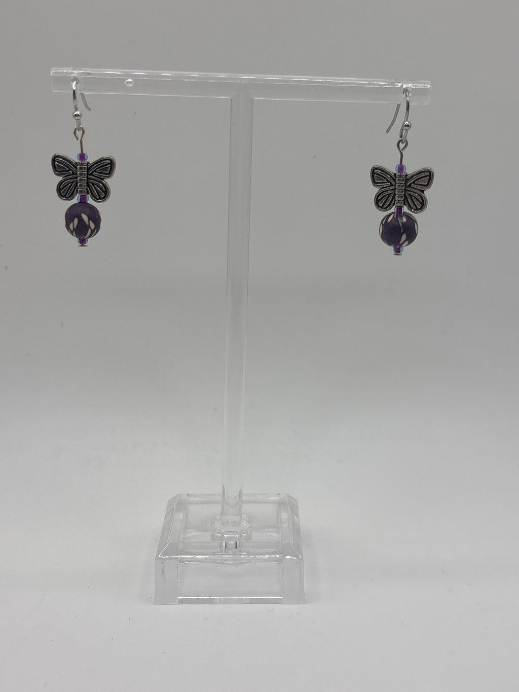 Silver tone butterfly with dark purple bead