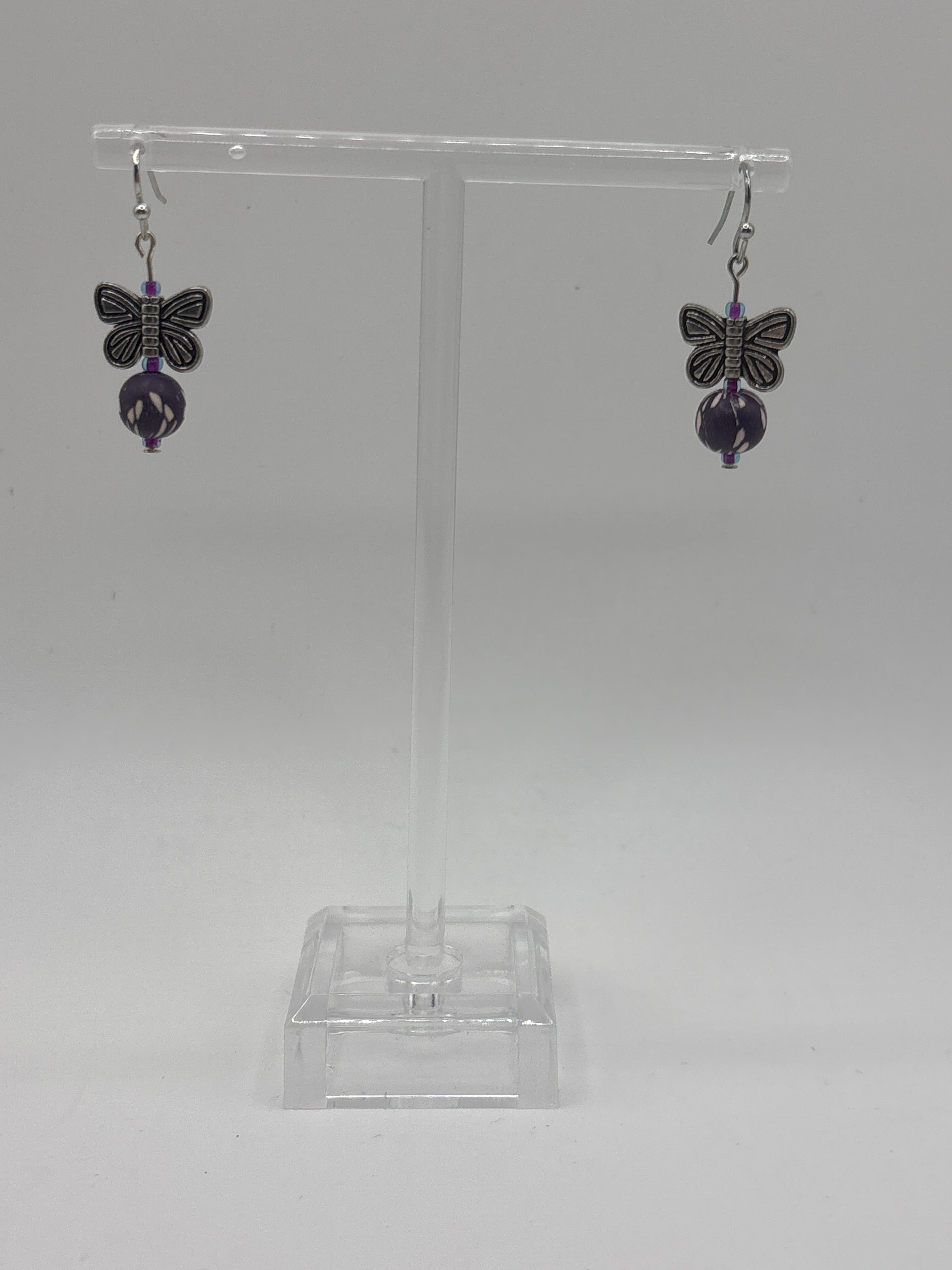 Silver tone butterfly with dark purple bead