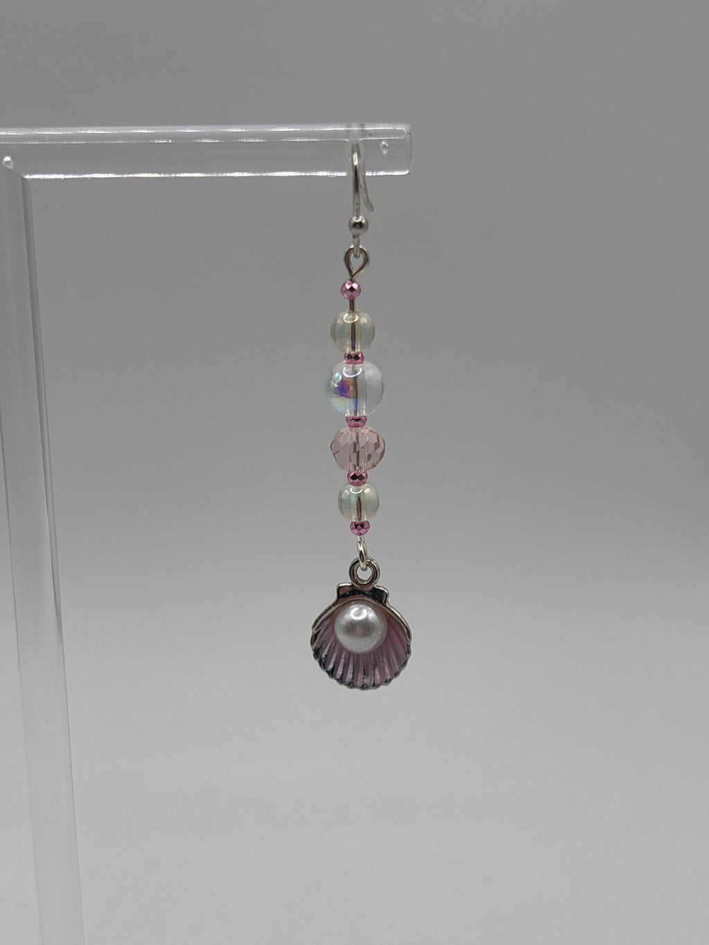 Pink shell with silver tone, pearl, bubbles and crystal.
