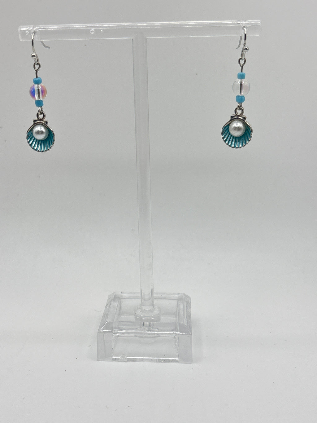 Silver tone shell with blue accents and pearl