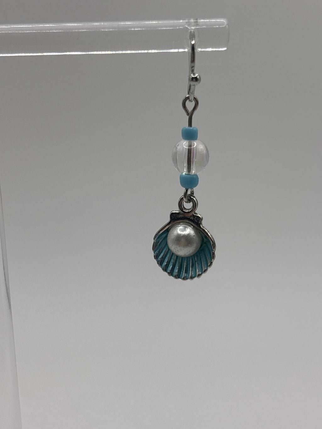 Silver tone shell with blue accents and pearl