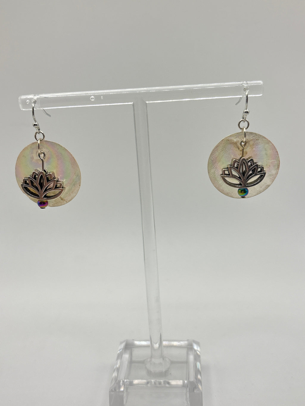 Silver tone lotus flower on iridescent shell
