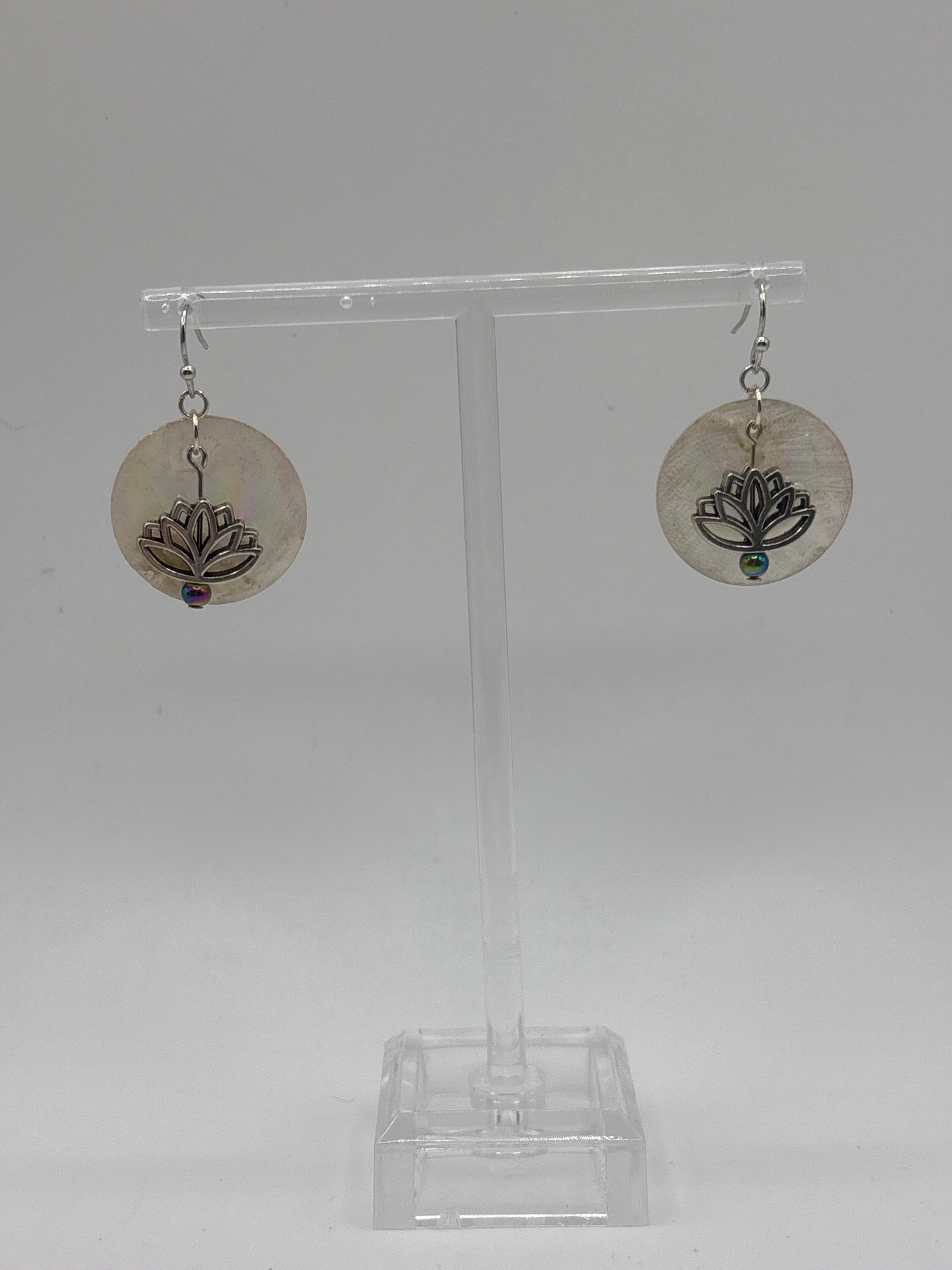 Silver tone lotus flower on iridescent shell