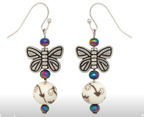 Silver tone butterfly on cream bead