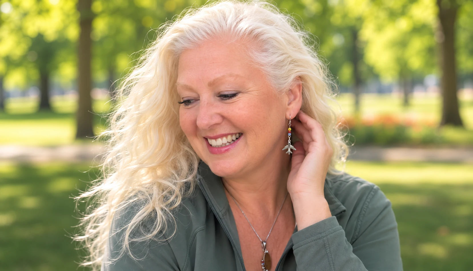Janet modeling colorful airplane earrings outdoors